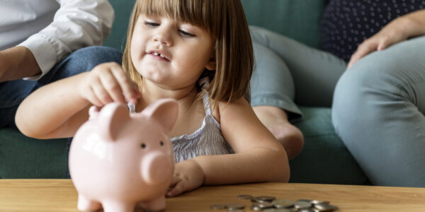 Family saving money in piggy bank